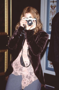 Drew Barrymore photo print at Show West 2000 in jeans and pink lace top.