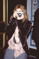 Drew Barrymore photo print at Show West 2000 in jeans and pink lace top.