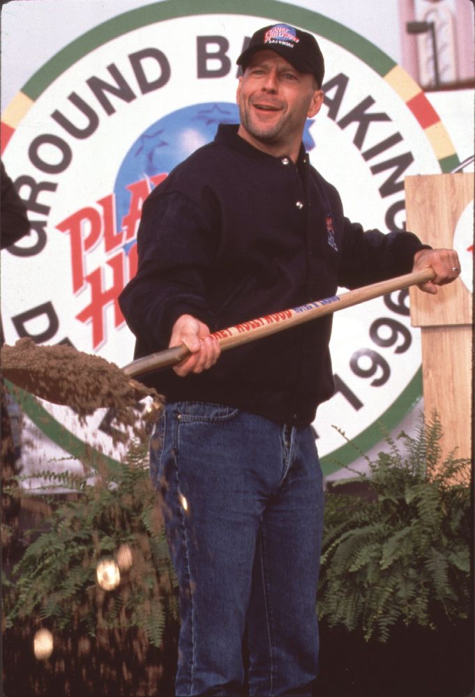 Bruce Willis holding a shovel at the Planet Hollywood groundbreaking ceremony photo print.