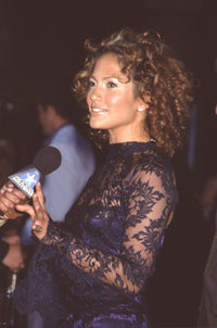 Jennifer Lopez talking to a reporter at the Angel Eyes movie premiere photo print.
