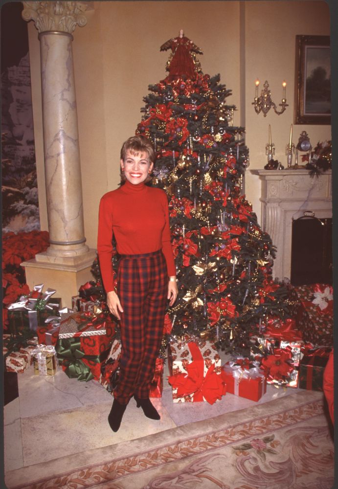 Vanna White in red sweatshirt and plaid pants in front of Christmas tree photo print