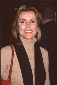Alex Donnelley close-up photo print in tan turtleneck and black scarf at Proof of Life premiere.