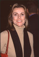 Alex Donnelley close-up photo print in tan turtleneck and black scarf at Proof of Life premiere.