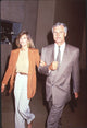 Photo print of Jane Fonda in an orange blazer with Ted Turner in a gray suit.