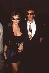 Raquel Welch in black mini skirt suit with André Weinfeld in sunglasses photo print.
