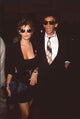 Raquel Welch in black mini skirt suit with André Weinfeld in sunglasses photo print.