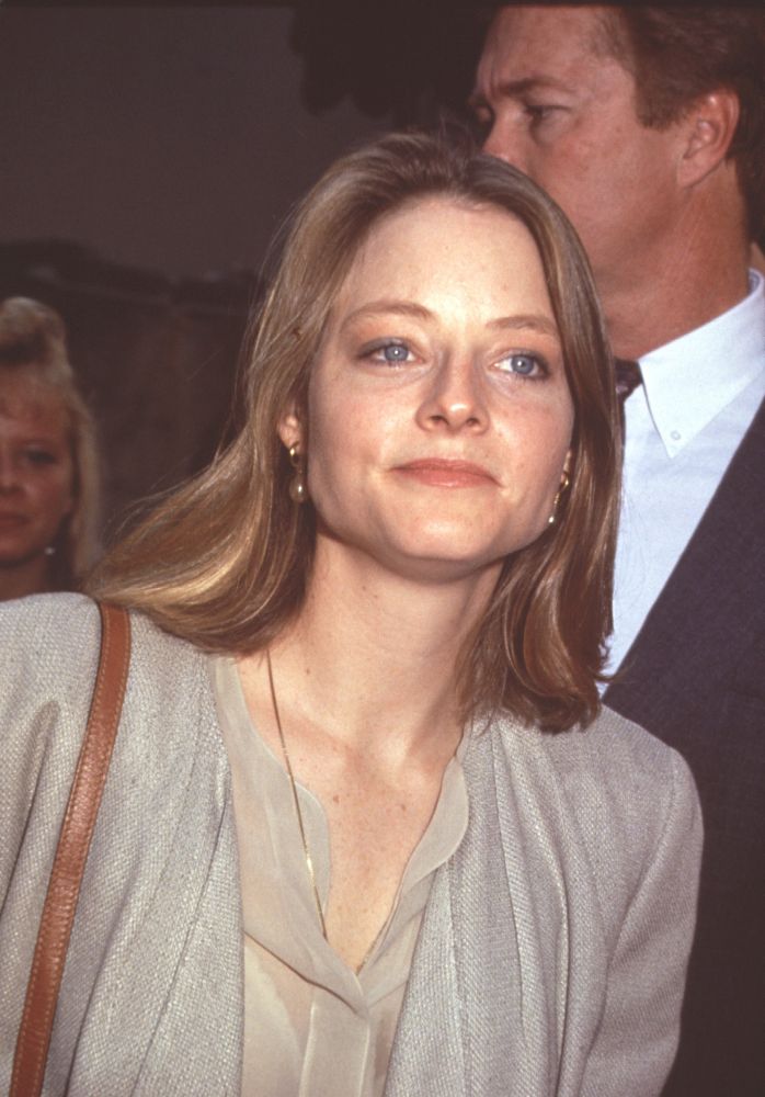 Jodie Foster photo print in tan top and brown leather purse.