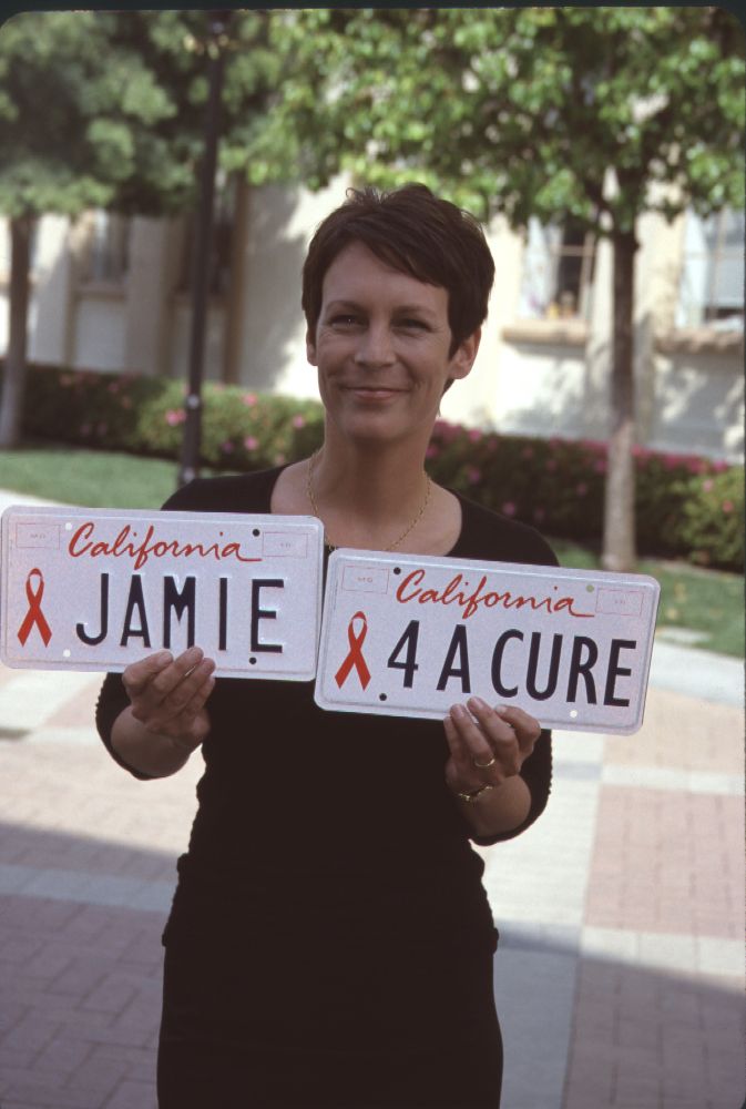 Jamie Lee Curtis holding a red ribbon at the Red Ribbon Event photo print.