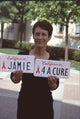 Jamie Lee Curtis holding a red ribbon at the Red Ribbon Event photo print.
