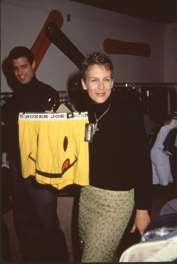 Jamie Lee Curtis holding yellow smiley face boxers at Divine Design 1999 photo print.