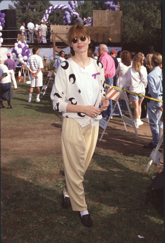 Geena Davis photo print wearing yellow pants and a white and black sweater.