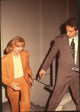 Geena Davis in orange suit with Gavin De Becker in brown suit at Bob Roberts premiere photo print.