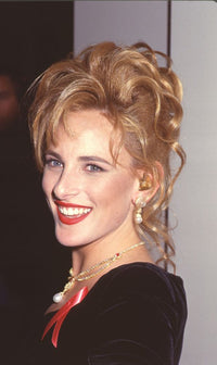 Marlee Matlin close-up photo print in velvet dress with red ribbon pin at the Golden Globes.