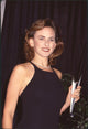 Marlee Matlin holding award in black dress at the 1994 Diversity Awards photo print.