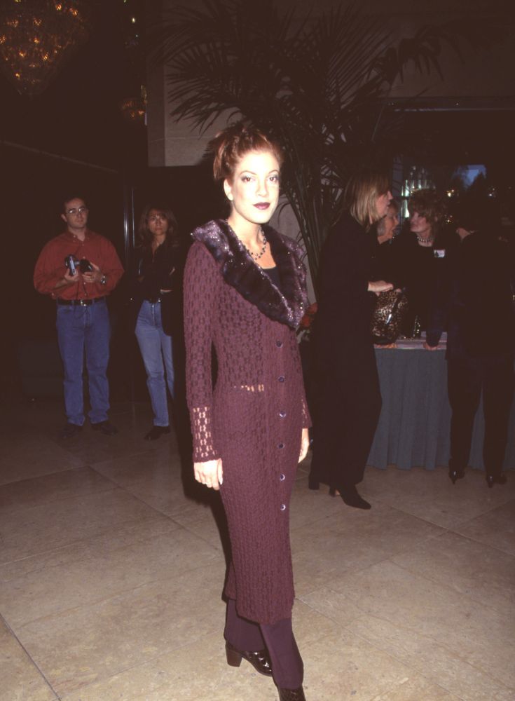 Tori Spelling in maroon outfit with fur trim at Golden Apple Awards photo print