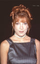 Tori Spelling close up photo print in gray pinstripe top at NATO Showest 25.
