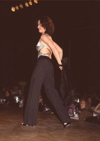 Kim Delaney on stage taking off jacket at Eras Center Fashion Show photo print.