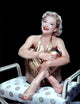 Anne Baxter in a gold jumpsuit photo print, capturing classic Hollywood glamour.