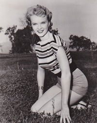 Anne Francis Kneeling in Grass Photo Print showcasing classic Hollywood beauty.