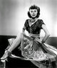 Ava Gardner On Table Photo Print showcasing the iconic actress in a timeless pose.