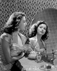 Ava Gardner Looking in Mirror Photo Print showcasing classic Hollywood elegance.