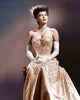 Ava Gardner wearing white gloves in a classic color photo print.