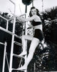 Barbara Stanwyck Ladder Photo Print showcasing classic Hollywood elegance.