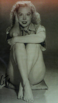 Betty Brosmer Sitting Photo Print showcasing vintage glamour and elegance.
