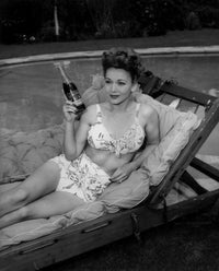 Carole Landis drinking cola photo print showcasing vintage charm.