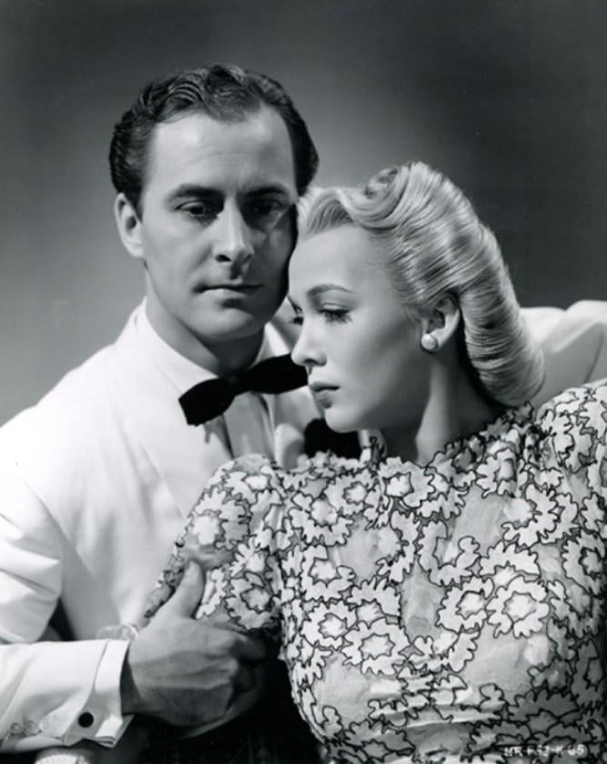 Carole Landis vintage photo print with a man holding her arm.