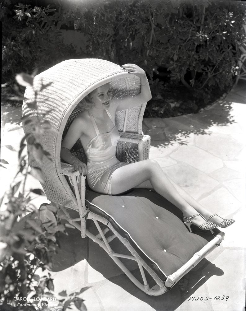 Carole Lombard sitting in a covered chair photo print