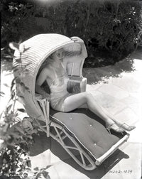 Carole Lombard sitting in a covered chair photo print