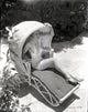 Carole Lombard sitting in a covered chair photo print
