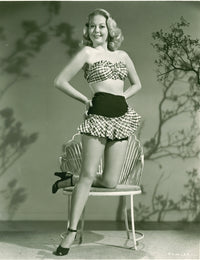 Adele Mara Pose on Chair Photo Print showcasing elegance and charm.