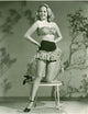 Adele Mara Pose on Chair Photo Print showcasing elegance and charm.