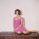 Claudia Cardinale sitting elegantly in a pink dress photo print