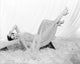 Cyd Charisse upside down on chaise photo print showcasing classic Hollywood elegance.