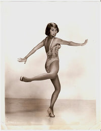 Photo print of Cyd Charisse dancing in a sequin one-piece outfit.