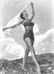 Cyd Charisse walking holding a scarf photo print.