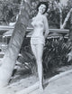 Cyd Charisse next to palm tree photo print showcasing classic Hollywood elegance.