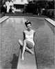 Cyd Charisse in white bathing suit on diving board photo print.
