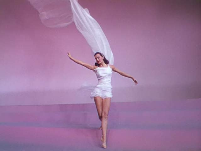 Cyd Charisse dancing in a white train photo print.