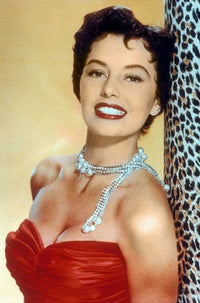 Cyd Charisse leaning on an animal print background photo print
