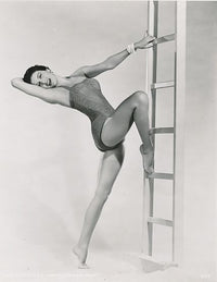 Cyd Charisse Leg on Ladder Photo Print showcasing classic Hollywood elegance.