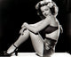 Dale Evans sitting with knees up photo print, capturing her joyful spirit.