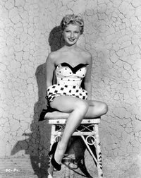 Dani Crayne in a square pattern swimsuit photo print.