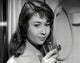 Dany Carrel Holding Glass Photo Print showcasing elegance and charm.