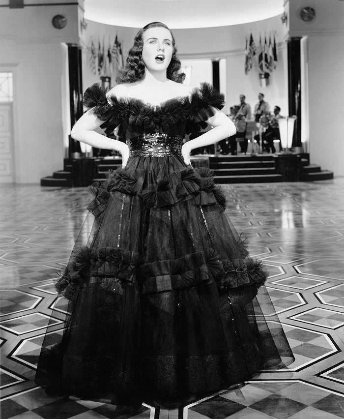 Deanna Durbin Hands on Hips Photo Print showcasing classic Hollywood glamour.