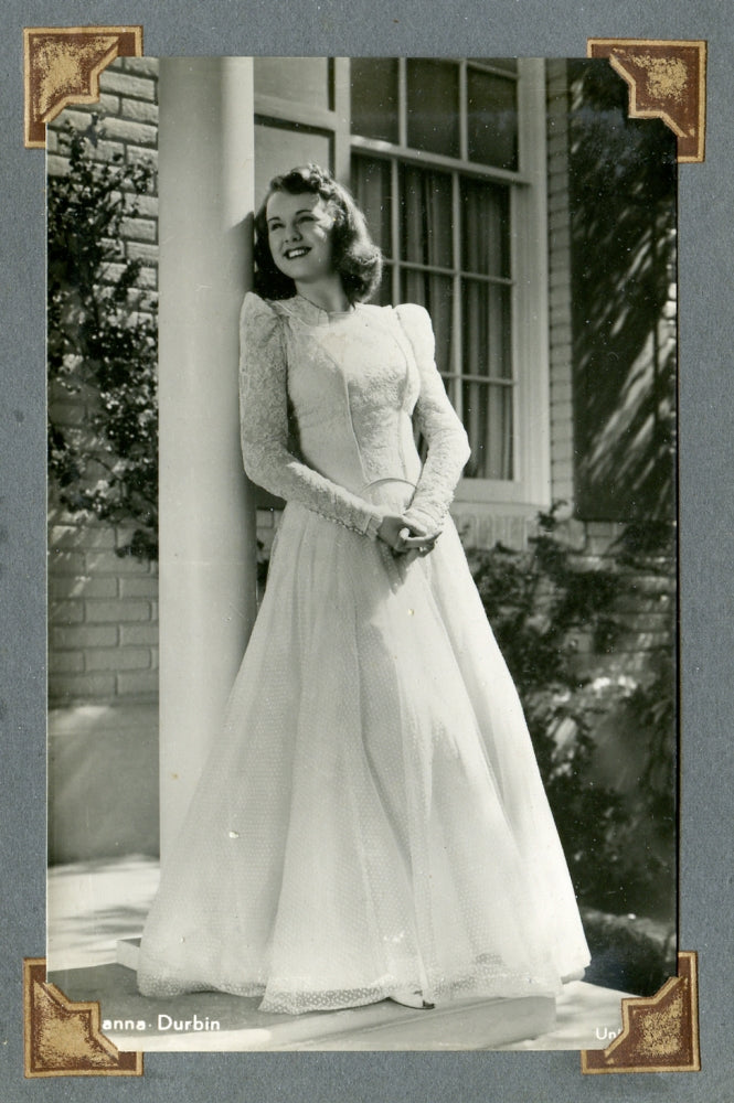 Deanna Durbin Leaning on Post Photo Print showcasing vintage Hollywood charm.