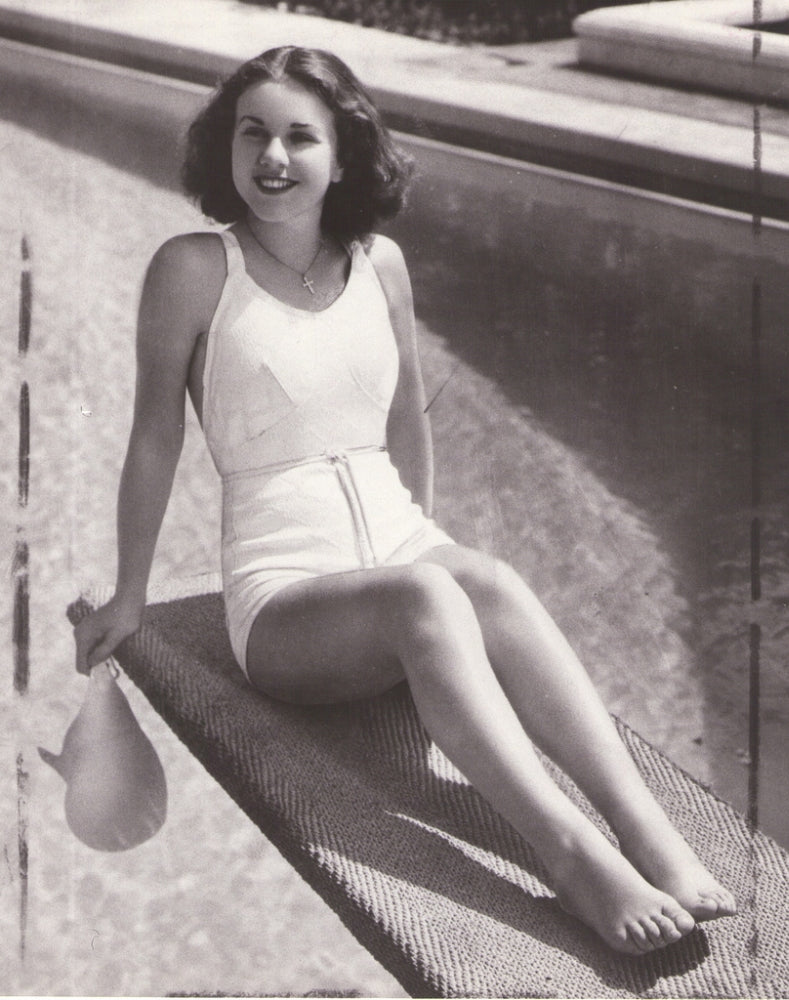 Deanna Durbing sitting on a diving board photograph
